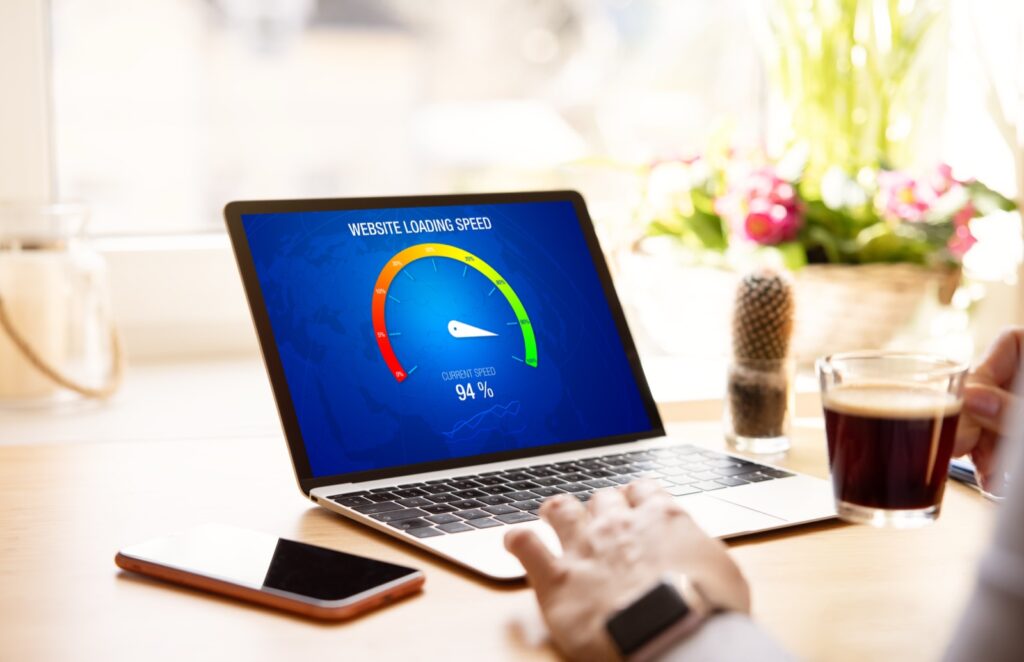 Laptop on a desk showing a website loading speed gauge reading 94 per cent